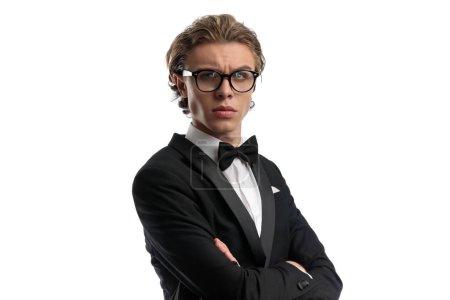 Photo for Young businessman looking away and wearing eyeglasses, wearing a formal outfit against white studio background - Royalty Free Image