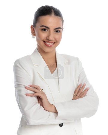 Photo for Portrait of elegant businesswoman in white suit folding arms and smiling in front of white background - Royalty Free Image