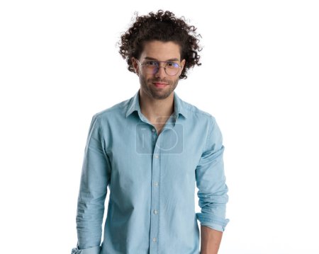 Photo for Portrait of attractive young man with curly hair wearing glasses and smiling on white background - Royalty Free Image