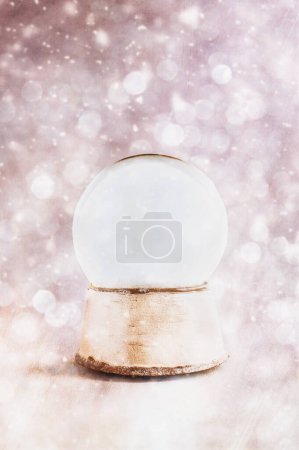 Photo for Blank snow globe with copy space. Surrounded by light flares and bokeh. Shallow depth of field with selective focus on snowglobe and copy space available. - Royalty Free Image