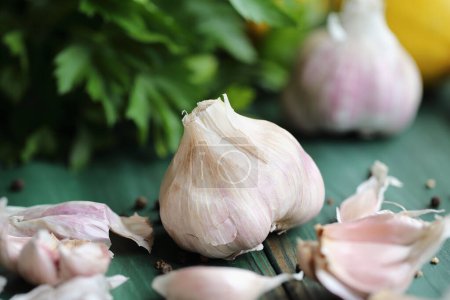 Photo for Fresh garlic cloves and ingredients to make toum sauce or a salad dressing. Closeup stock photo with selective focus and blurred background. - Royalty Free Image