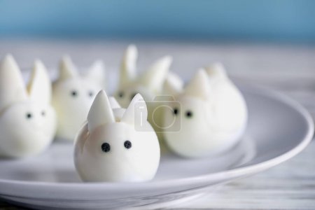 Photo for Fun food for kids. Hard boiled baby bunny eggs perfect for Easter parties. Alternative to candy. Shallow depth of field with selective focus on egg at edge of plate. - Royalty Free Image