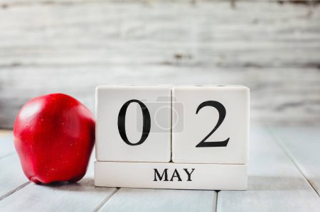 Photo for White wood calendar blocks with the date May 2nd and a red apple for National Teacher Appreciation Day. - Royalty Free Image