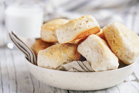 Photo for Delicious freshly baked buttermilk southern biscuits or scones made from scratch. Selective focus with blurred background. - Royalty Free Image
