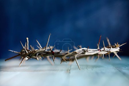 Photo for Christian crown of thorns like Jesus Christ wore with blood drops over a rustic wood background or table. Selective focus with blurred background. - Royalty Free Image