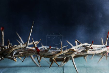 Photo for Dark moody Christian crown of thorns like Jesus Christ wore with blood drops over a rustic wood background or table. Selective focus with blurred background. - Royalty Free Image