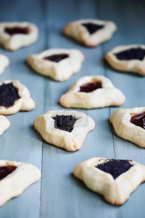 Photo for Variety of traditional hamantaschen cookies filled with mohn paste (poppy seed paste) and plum jam for the Jewish festival of Purim. - Royalty Free Image