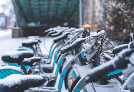 Photo for Rental city bikes at docking station covered with snow. - Royalty Free Image