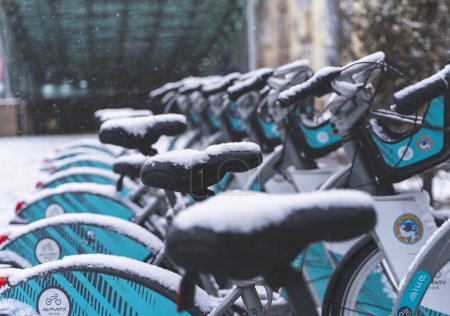 Photo for Almaty, Kazakhstan - December 09, 2022 - Rental city bikes at docking station covered with snow. - Royalty Free Image