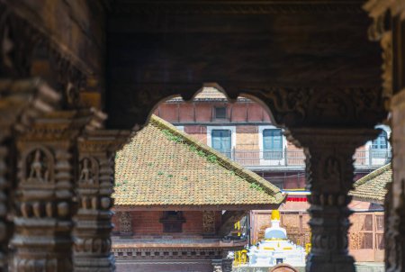 Photo for Wooden carved pillars and view through the arch in the temple of Durbar square at Patan Kathmandu, Nepal. - Royalty Free Image