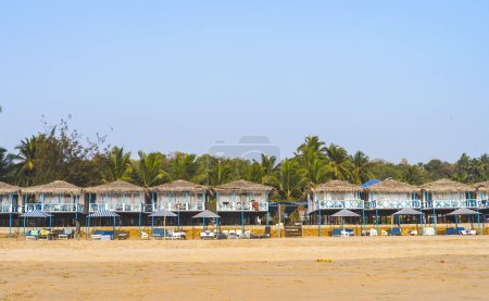 Photo for Colorful huts in Agonda beach with palm trees in Goa, India - Royalty Free Image
