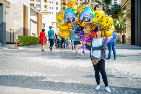 Photo for Dubai, UAE, February 23, 2018: A party balloon vendor at the Jumeirah Beach Residence (JBR) Walk - a polular destination for food, shopping and entertainment - Royalty Free Image