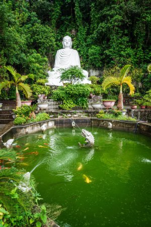 Photo for Ornamental garden with a Buddha statue on the Marble Mountain in Vietnam - Royalty Free Image