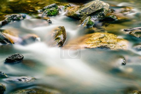 Photo for Long exposure image of water streaming around the rocks in a creek in North Carolina - Royalty Free Image