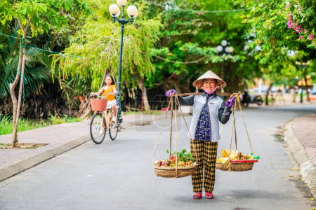 Photo for Hoi An, Vietnam, November 20, 2022: A street fruit vendor in the city of Hoi An in Vietnam - Royalty Free Image