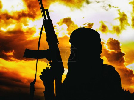 Foto de Militante musulmán con rifle en el desierto al atardecer con rifle AK - Imagen libre de derechos