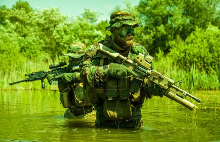 Soldiers move in the heart of a marsh, crossing swampy waters, tropical jungle heat, extreme conditions of concealed tactical combat operations of special task forces