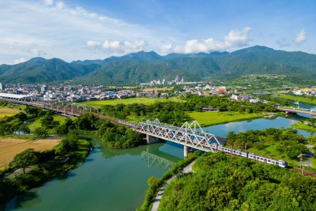 Photo for Train pass the iron bridge at dongshan river eco park in yilan, taiwan - Royalty Free Image