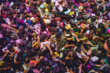Photo for March 1, 2018: Vibrant colours whirled in air at Bankey Bihari Temple in  Vrindavan, Mathura, India. Holi is an ancient Hindu festival, aka festival of spring, that celebrates the arrival of spring - Royalty Free Image