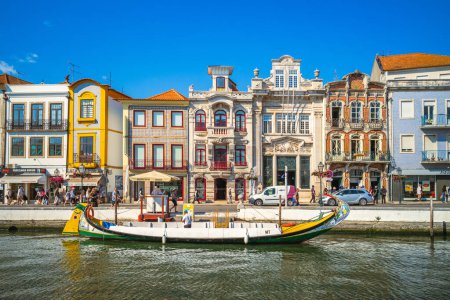 Photo for September 27, 2018: Boat on Canal and Art Nouveau, Novo, buildings in Aveiro in Portugal. Aveiro was a center of salt exploration by the Romans and trade center through the Middle Ages. - Royalty Free Image