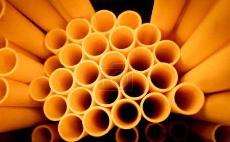 Photo for Background of the orange plastic pipes in stacked. - Royalty Free Image