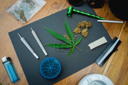 Photo for Joints and buds of medical cannabis and cigarettes on a wooden table. - Royalty Free Image