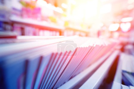 Photo for Different books lying on the shelves in the book store. - Royalty Free Image