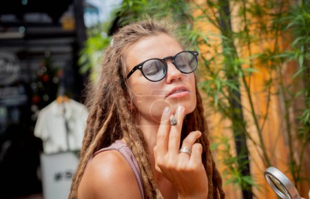 Photo for Hippie style woman smoking cigarettes with medical marijuana. - Royalty Free Image