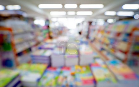 Photo for Bloored background of the book store with different books lying on the shelves. - Royalty Free Image