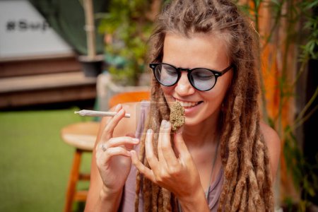 Photo for Hippie style woman smoking cigarettes with medical marijuana. - Royalty Free Image