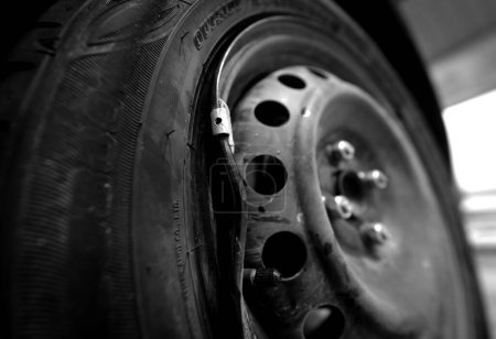 Photo for Car with a punctured and broken wheel in a car repair shop. - Royalty Free Image