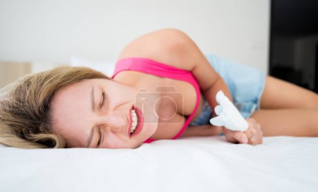 Photo for Beautiful woman feels pain during menstruation on the bed. - Royalty Free Image