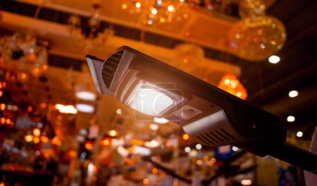 Téléchargez les photos : Solar-powered street lamp at the showroom of a large store. - en image libre de droit