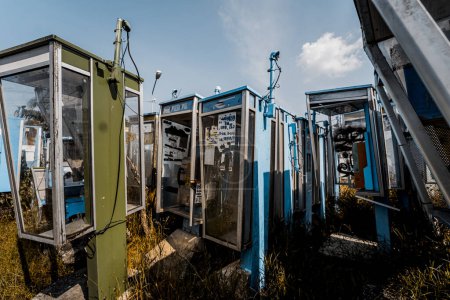 Photo for Old and dirty street phones at the city landfill. - Royalty Free Image