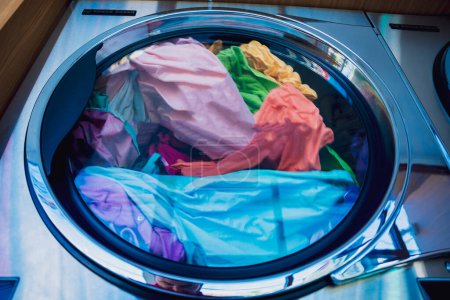 Photo for Washed and dried clothes laundry machines in the large laundromat - Royalty Free Image