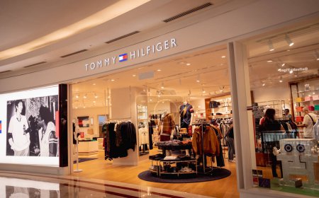 Photo for KUALA LUMPUR, MALAYSIA - DECEMBER 04, 2022: Tommy Hilfiger brand retail shop logo signboard on the storefront in the shopping mall. - Royalty Free Image