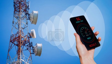 Photo for Hands with a phone on the background of 5G cell towers receiving a signal. - Royalty Free Image