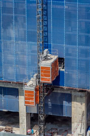 Photo for Big elevator on the exterior of a new building construction. - Royalty Free Image