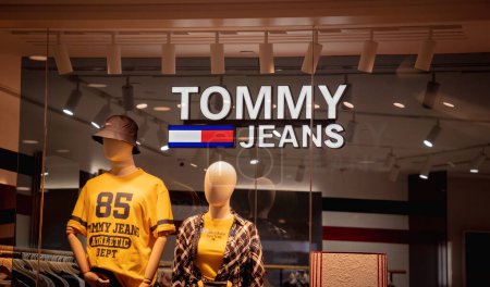 Photo for KUALA LUMPUR, MALAYSIA - DECEMBER 04, 2022: Tommy Hilfiger brand retail shop logo signboard on the storefront in the shopping mall. - Royalty Free Image