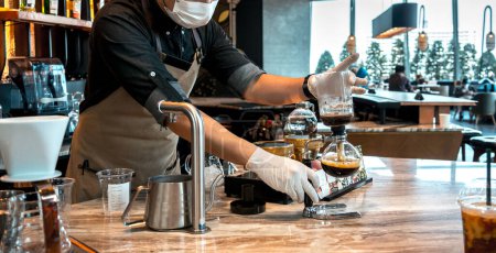 Photo for Barista preparing coffee drink at the big shopping mall. - Royalty Free Image