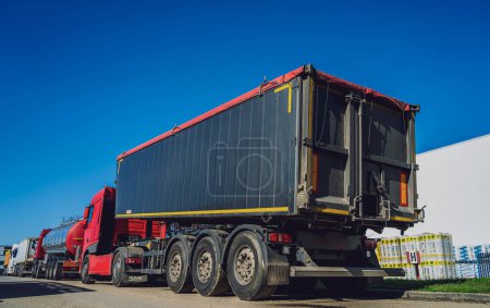 Photo for Cargo trucks along the road at the blue sky background. - Royalty Free Image