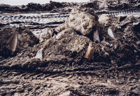 Photo for Excavator tire tracks footprint on construction road site. - Royalty Free Image