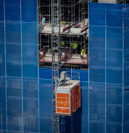Photo for Big elevator on the exterior of a new building construction. - Royalty Free Image