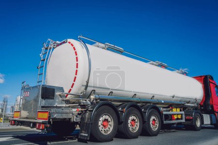 Photo for White tanker truck transporting fuel along the road at the blue sky background. - Royalty Free Image
