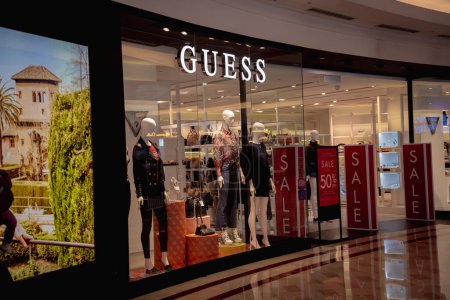Photo for KUALA LUMPUR, MALAYSIA - DECEMBER 04, 2022: Guess brand retail shop logo signboard on the storefront in the shopping mall. - Royalty Free Image