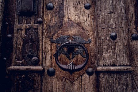Photo for A wooden door with beautiful bronze handle knocker - Royalty Free Image