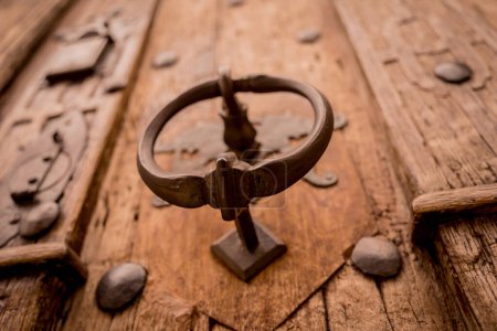 Photo for A wooden door with beautiful bronze handle knocker - Royalty Free Image