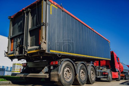 Photo for Cargo trucks along the road at the blue sky background. - Royalty Free Image