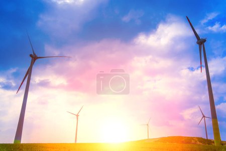 Photo for Windmill farm at the fields with beautiful blue sky. - Royalty Free Image