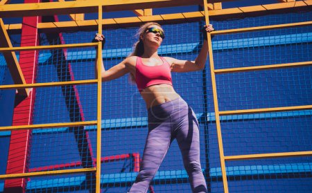 Photo for Athletic young woman working out and climbing at the training camp - Royalty Free Image